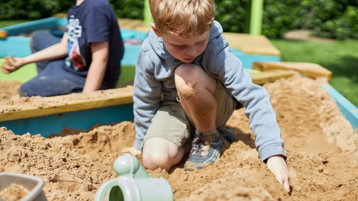 A boy plays in a sand pit during Summer of Play at Wentworth Castle Gardens